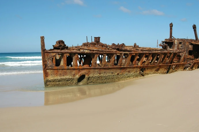 ship wreck docked on beach during day time